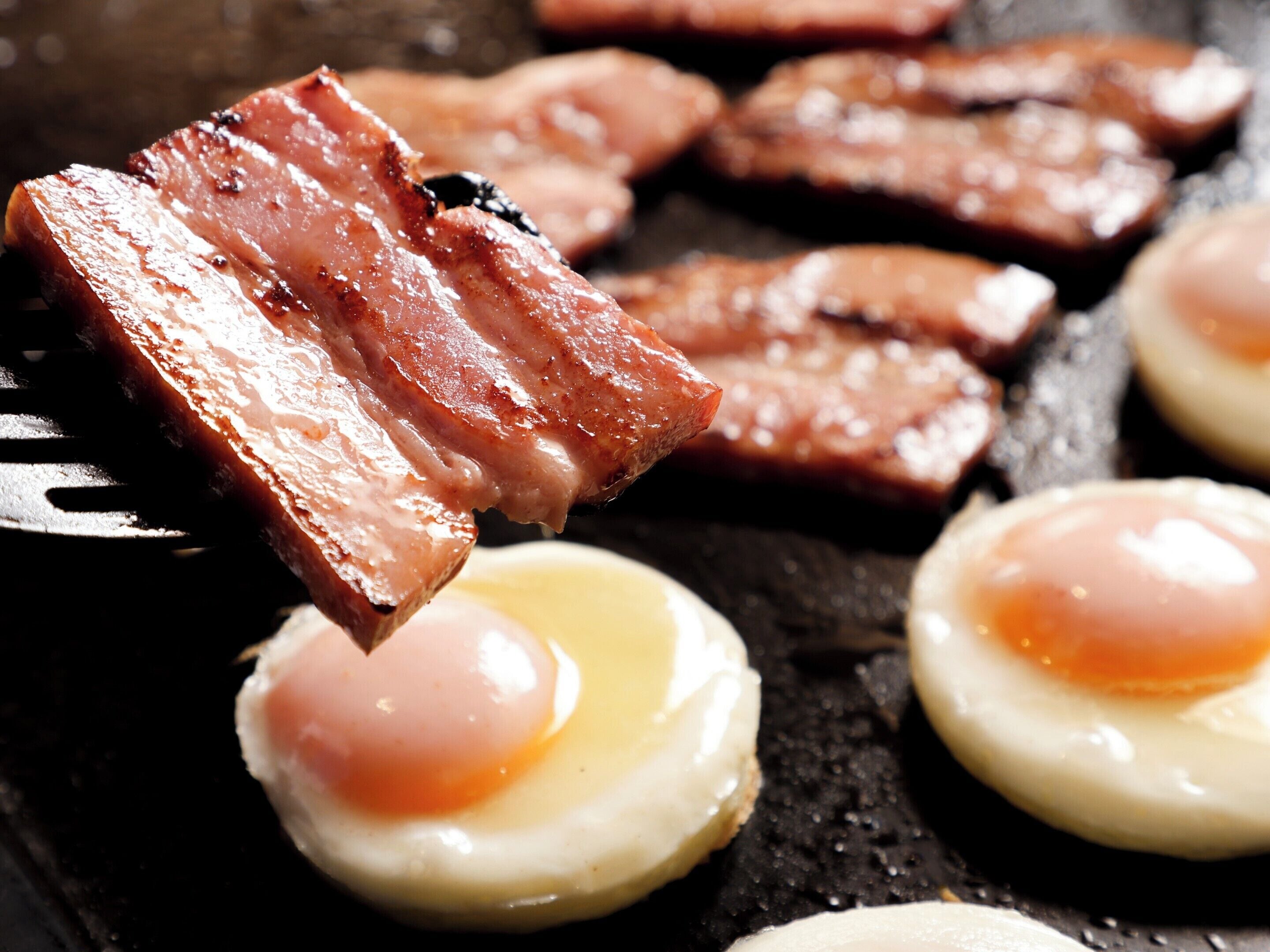 A breakfast plate with bacon and eggs.