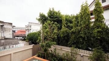 A rooftop pool with a view of surrounding buildings and trees.