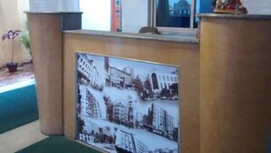 A framed historical photograph of buildings and a statue on a pedestal. - Green Leaf Regency  (Kolkata)