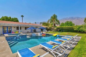 A swimming pool with lounge chairs, a covered area, and a view of mountains. - Saltwater Pool & Spa, Fire Pit, Expansive Mountain View (Palm Springs)