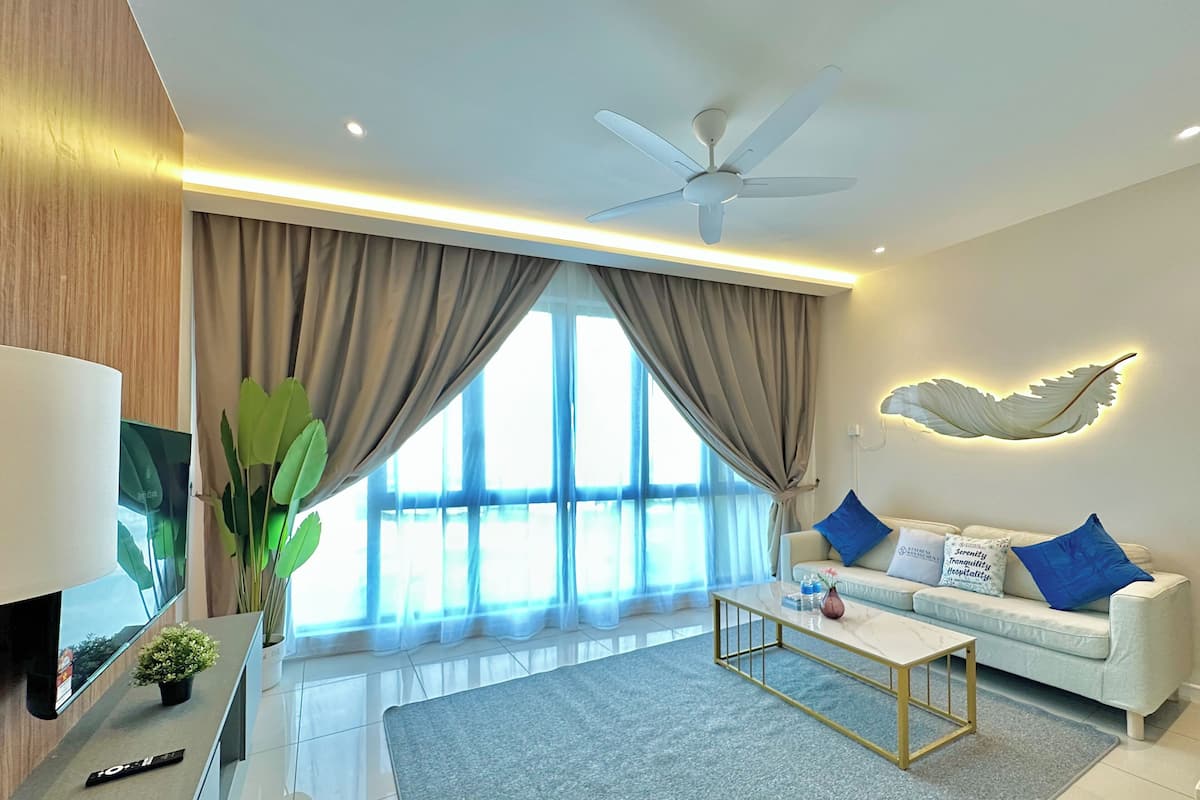 A modern living room with a sofa, coffee table, and a ceiling fan.