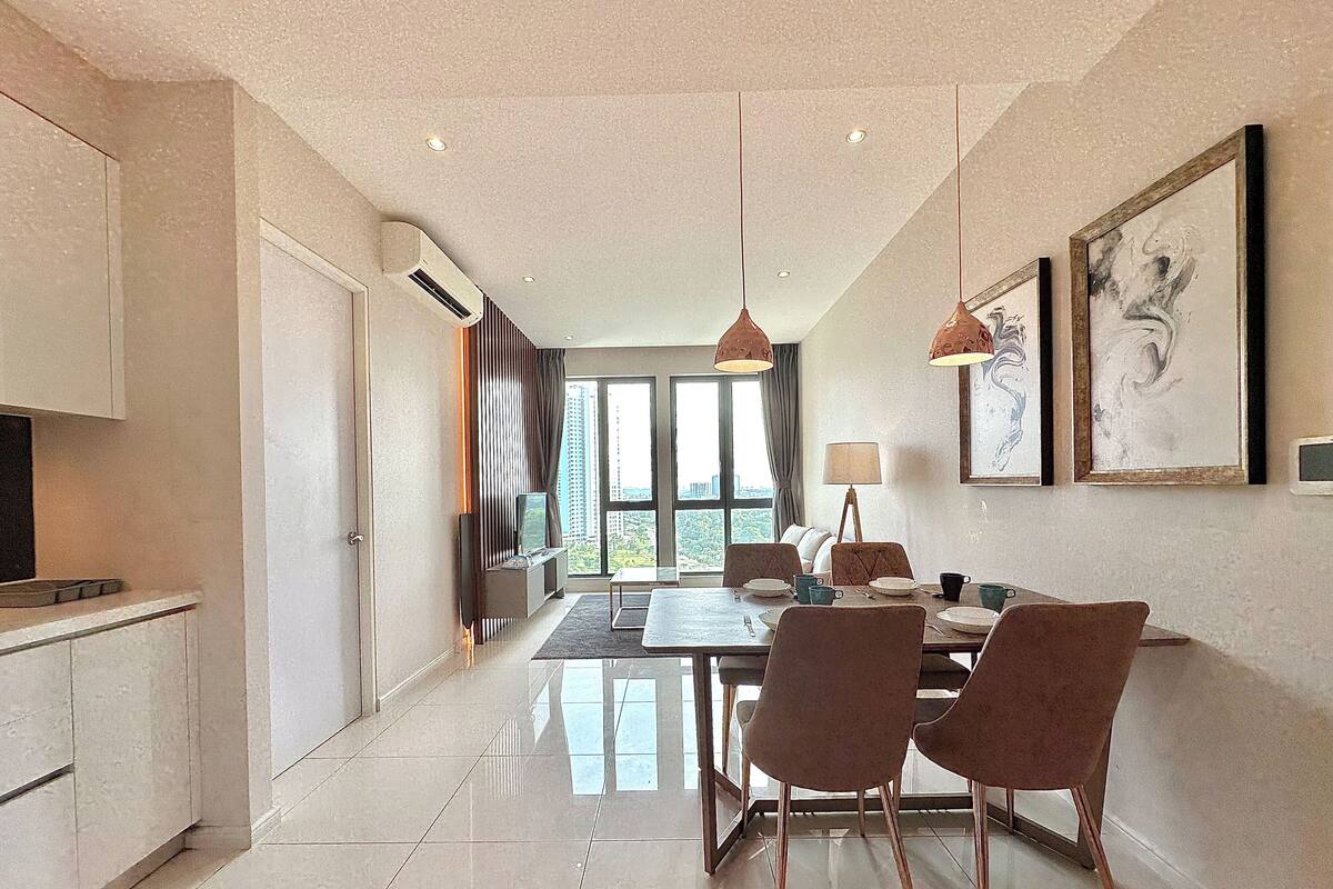 A modern dining area with a table, chairs, and artwork on the walls.