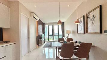 A modern dining area with a table, chairs, and artwork on the walls.