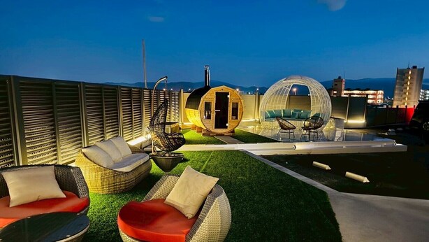A rooftop terrace with wicker furniture, a small wooden structure, and a spherical glass lounge. - Luxury Hills1500 ㎡ Superb view patio Sauna BBQ 4 parking spaces, swimming pool, pets, near Fukuoka Airport (Kanenokuma, Hakata-ku, Fukuoka City)