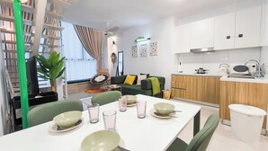 A modern apartment with a dining area, kitchen, and living space. - Kuchai Sentral by Manhattan Group (Kuala Lumpur)