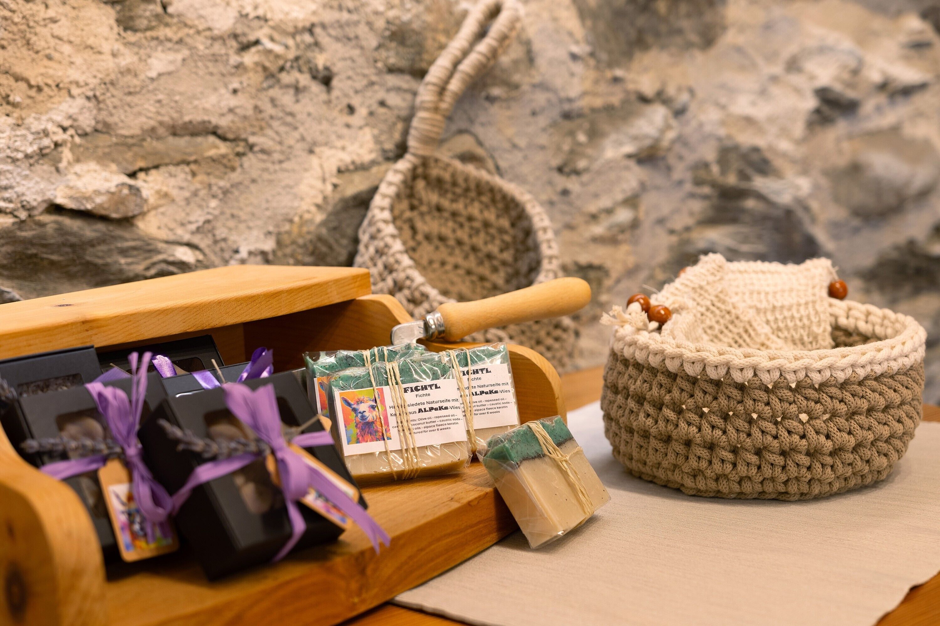 A wooden cart with packaged items, a woven basket, and a knitted item.