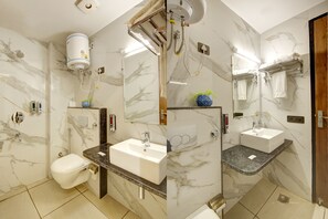 A bathroom with a white toilet, a sink, and a shower. - Hotel Armani-Free Airport Pickup Aur Drop (New Delhi)