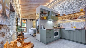 A kitchen with a herringbone tile backsplash, wooden cabinets, and a built-in oven.