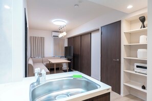 Basic Suite | Living area | 0-inch flat-screen TV with cable channels