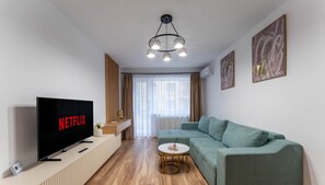 Deluxe Apartment, Balcony, Mountain View | Living area | 125-cm Smart TV with cable channels, Netflix, streaming services