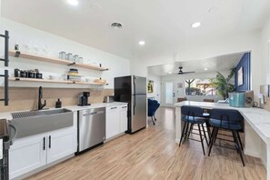 A modern kitchen with a stainless steel refrigerator, white cabinets, and a wooden countertop. - Central Phoenix Apt w/ Pool & Gazebo (Phoenix)