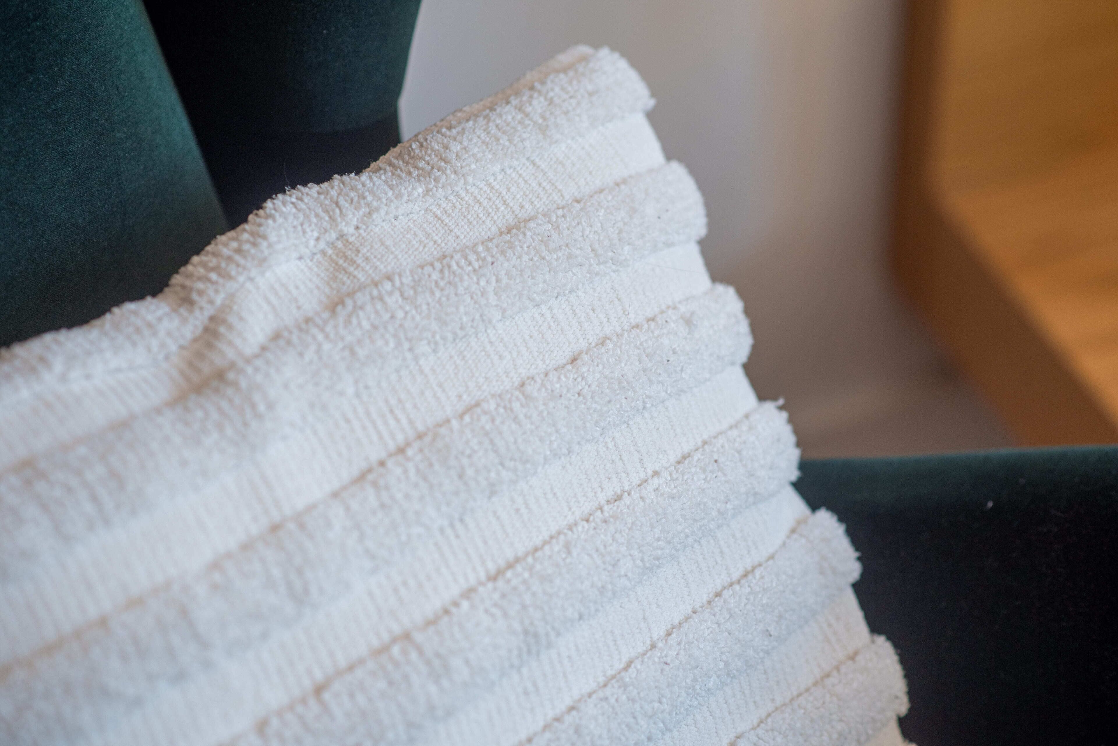 A white towel with horizontal stripes.