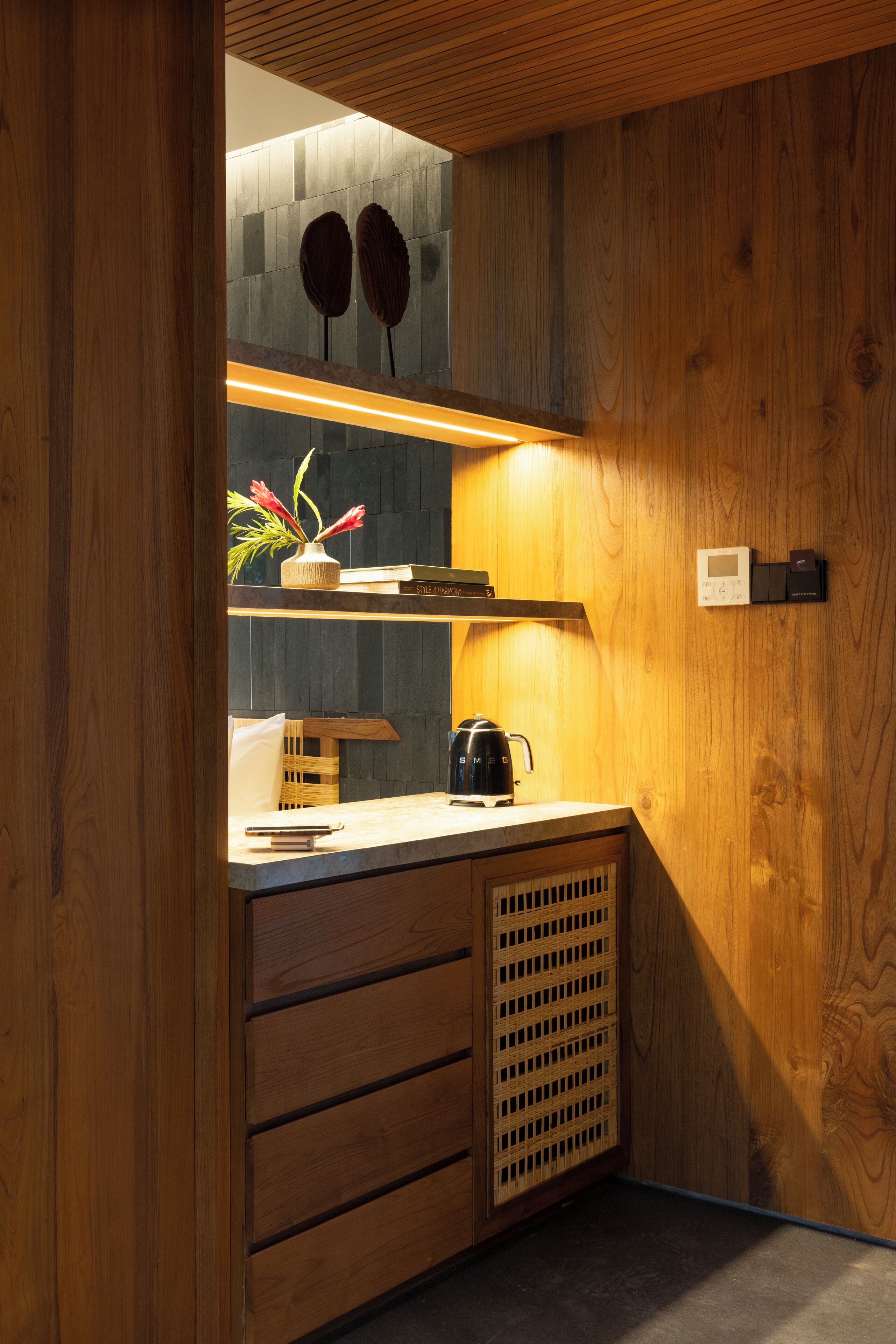 A compact kitchen with wooden cabinetry, a built-in stove, and a small countertop.