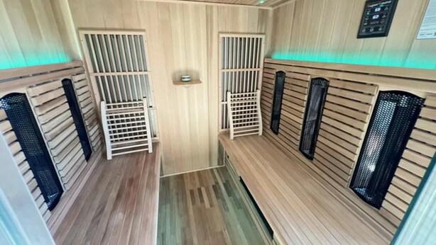 A sauna room with wooden walls and benches, a control panel, and a ventilation system. - Villa Marie Frances (DURBUY)