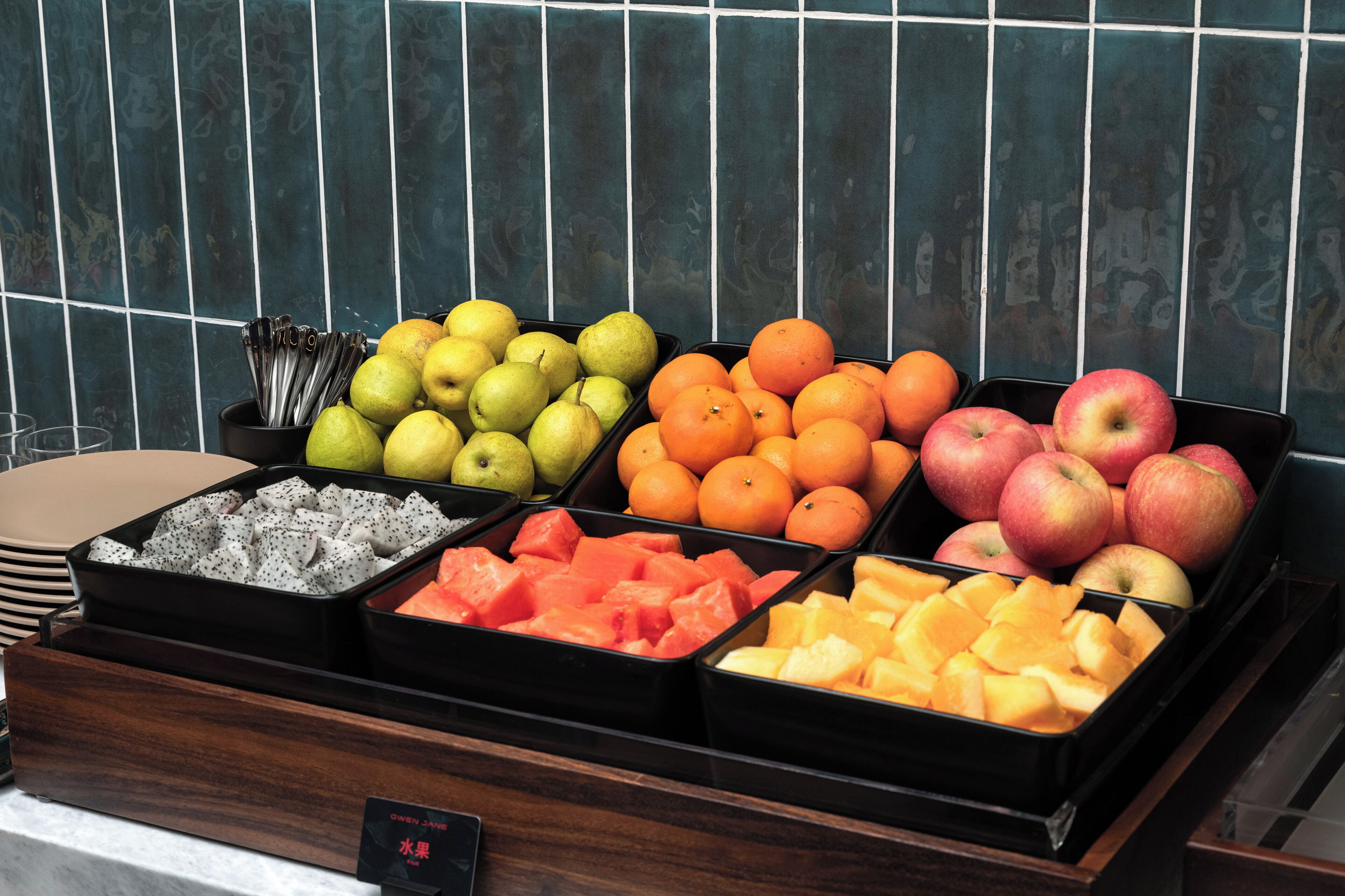 A fruit display with various fruits in trays.