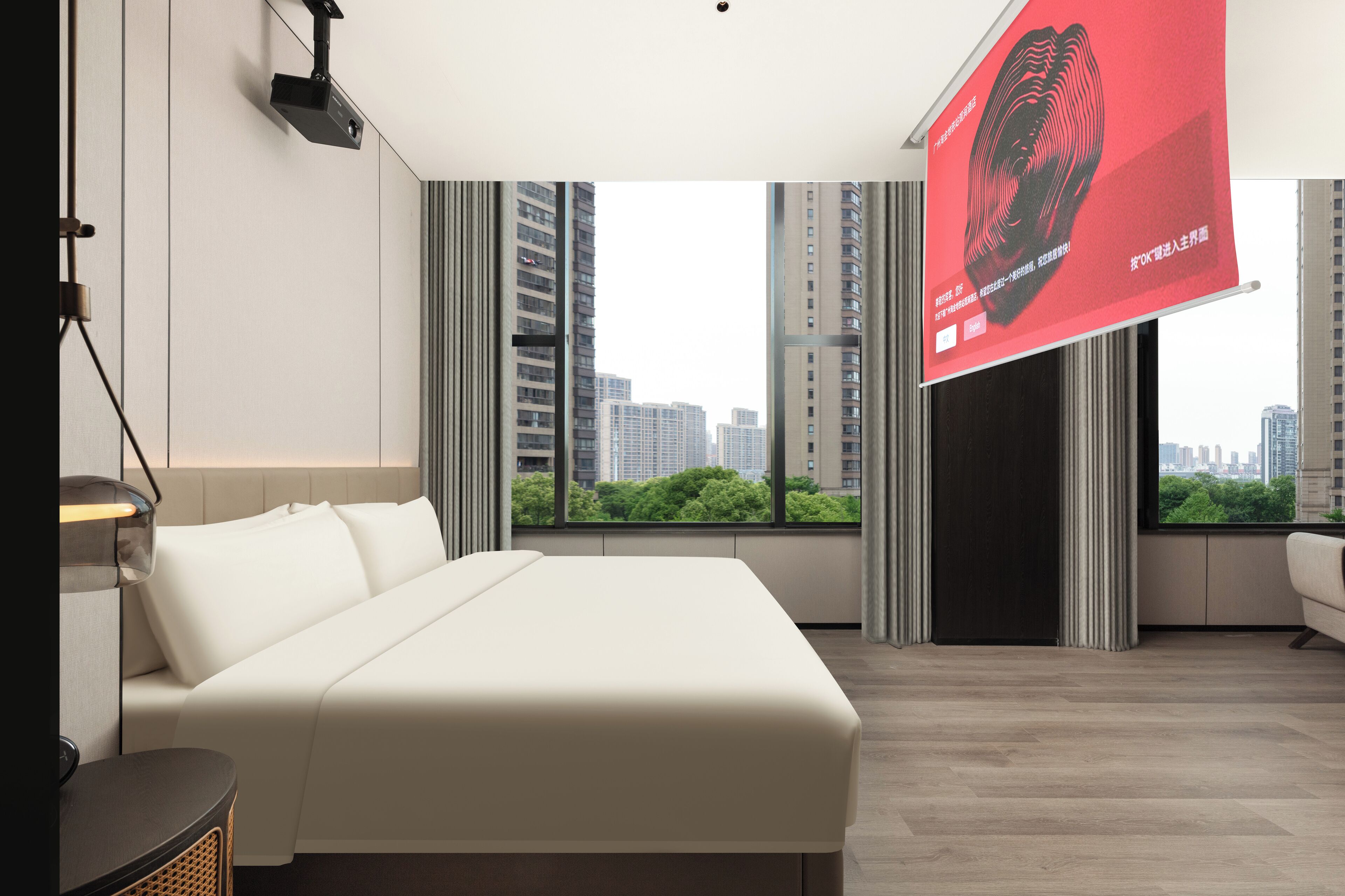 A modern hotel room with a large bed, a desk, and a view of the cityscape through large windows.