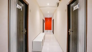 A hallway with doors numbered 203 and 206, leading to rooms. - Hotel Priceless (Mumbai)