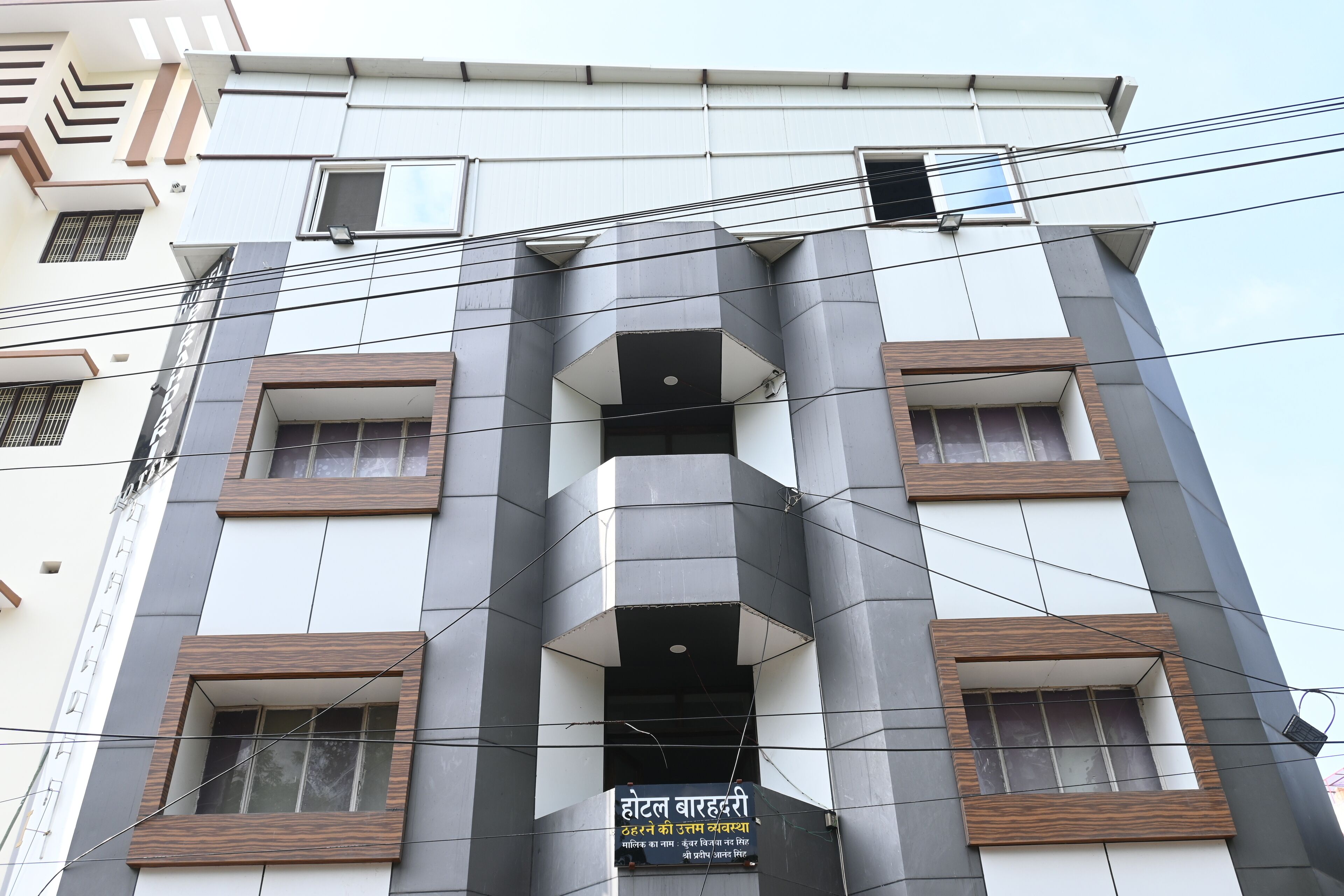 Un edificio de hotel con fachada moderna, varios balcones y un letrero que indica que es un hotel.