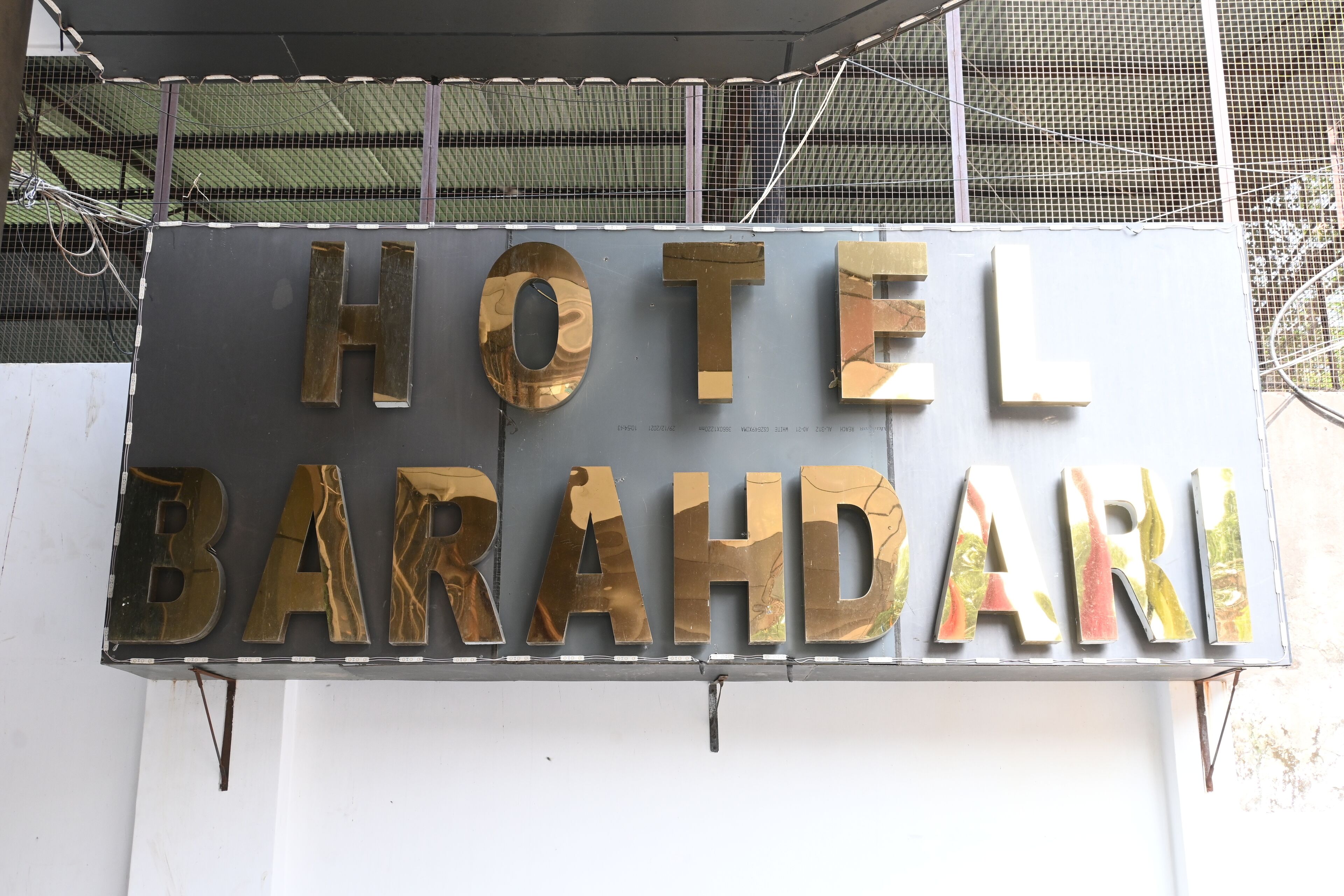 A sign for HOTEL BARAHDARI with large, metallic letters.