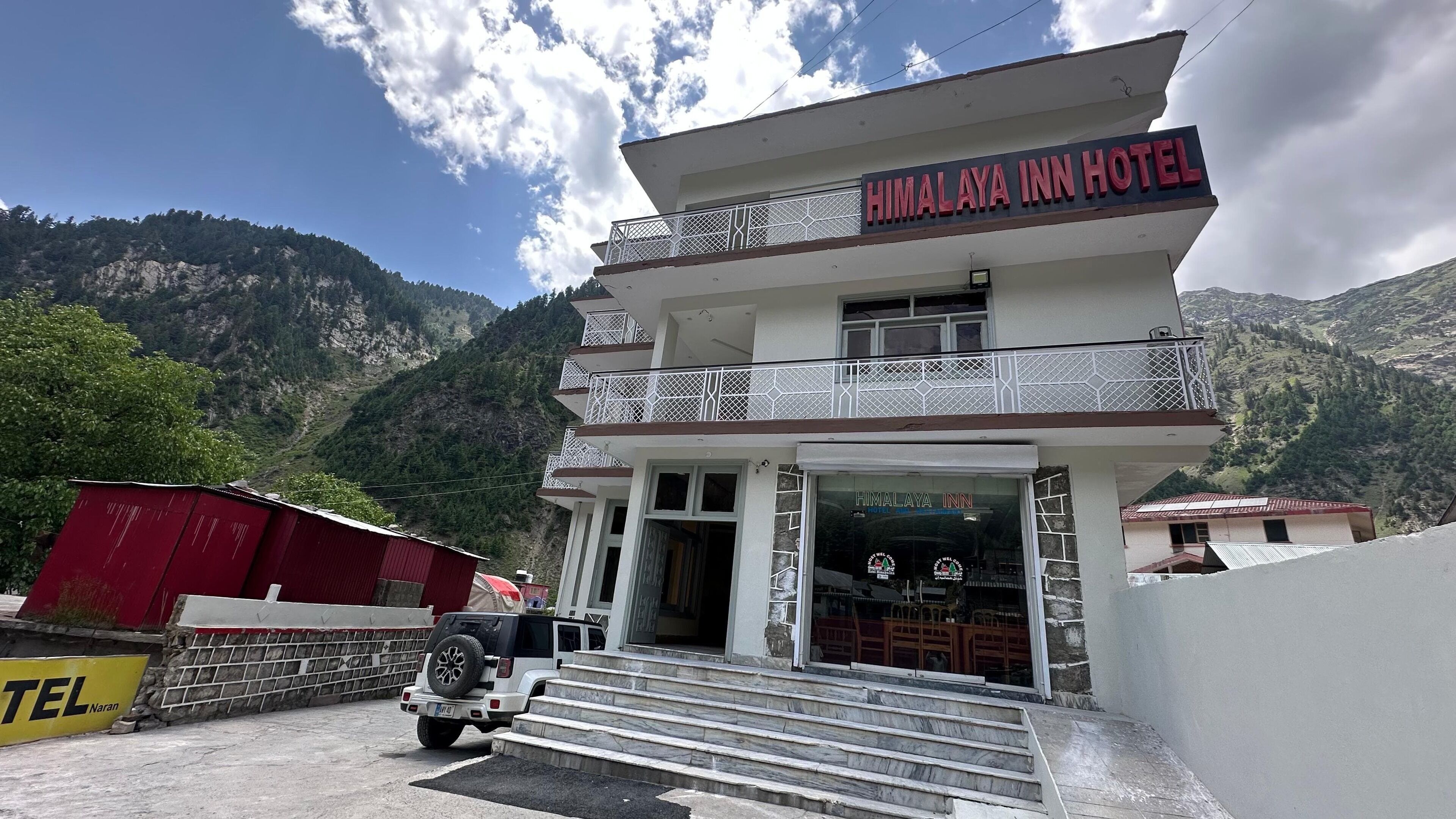 A two-story building with a sign reading "HIMALAYA INN HOTEL".