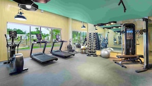 A gym with treadmills, a weight bench, and various exercise equipment. - Ginger Ekta Nagar, Statue of Unity (Garudeshwar)