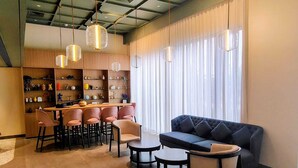 A modern interior with a bar area, seating, and decorative shelves. - Ginger Ekta Nagar, Statue of Unity (Garudeshwar)