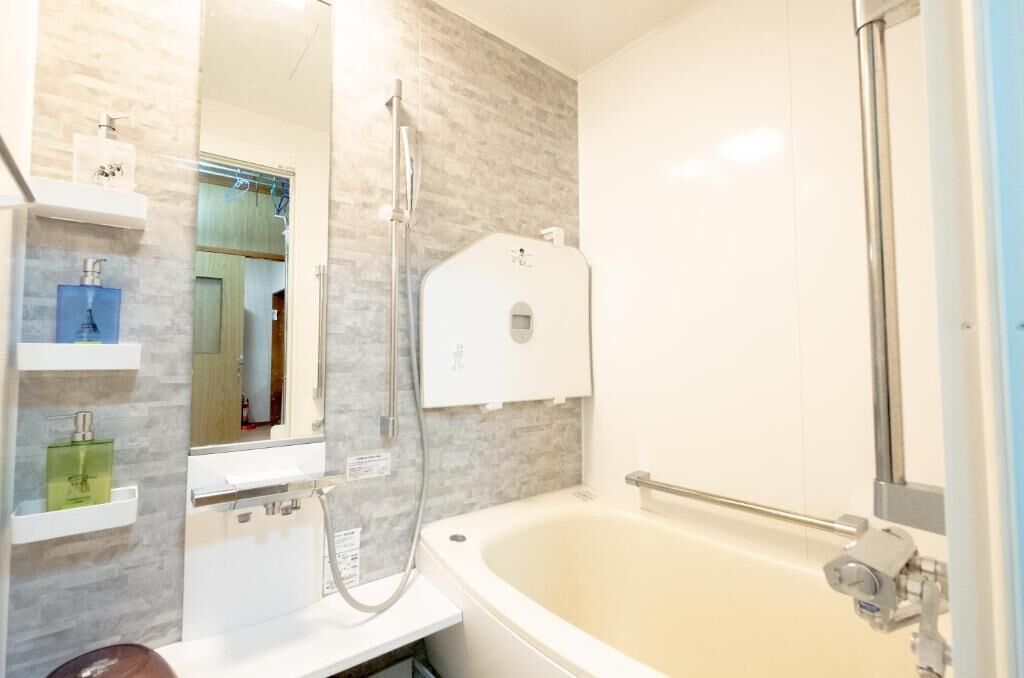 A modern bathroom with a bathtub, a shower, and a vanity with shelves.
