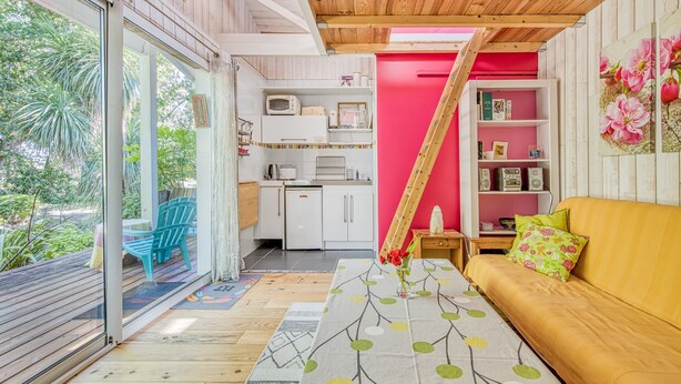 A modern kitchen with white cabinets, a microwave, and a toaster. - Pretty Little Chalet on the Silver Coast (Le Porge)