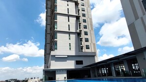 A modern building with a rooftop infinity pool, large windows, and a clear sky. - The Grand Subang Jaya SS15 By Emily in Town (Subang Jaya)