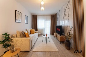 Apartamento luxo | Área de estar | Smart TV 125 cm com canais a cabo, Netflix, serviços de streaming