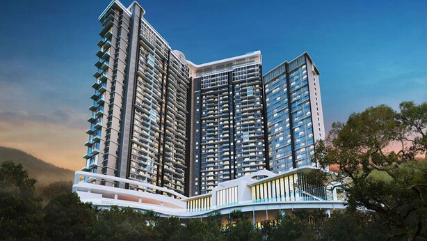 A modern high-rise building with multiple balconies, a curved entrance, and a bridge connecting to another structure.