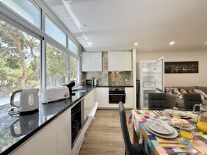 Microwave, dishwasher, coffee/tea maker, cookware/dishes/utensils