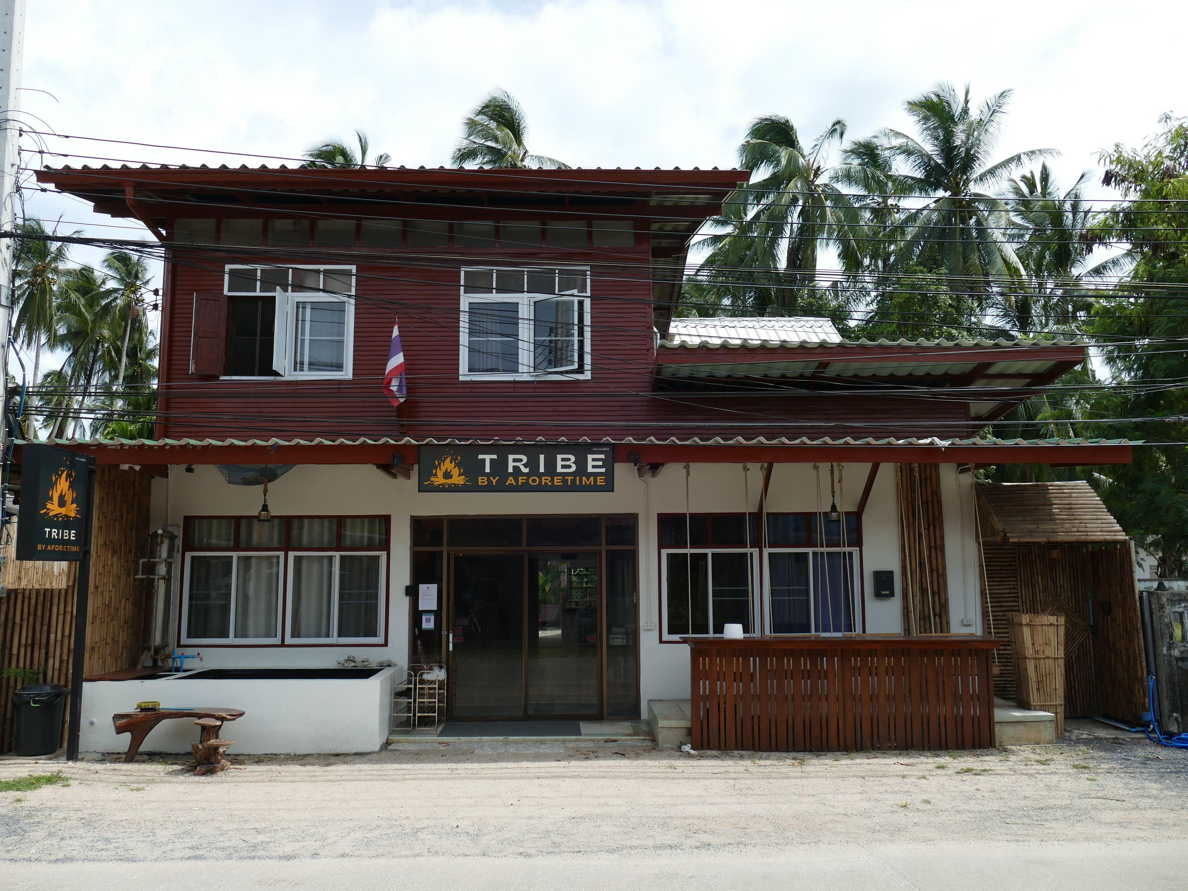 A two-story building with a sign reading 'TRIBE BY AFORETIME.'