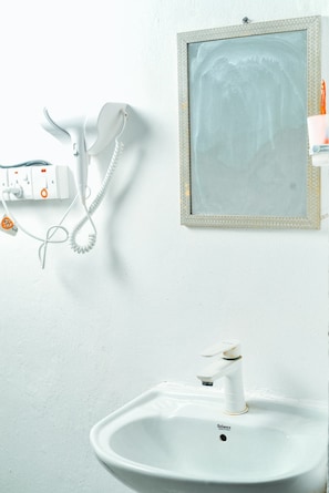 Family Townhome, City View | Bathroom | Slippers - Breflection Spa and Hostel (Zanzibar Town)