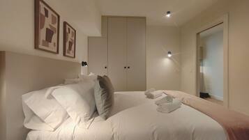 A bedroom with a large bed, a wardrobe, and a mirror.