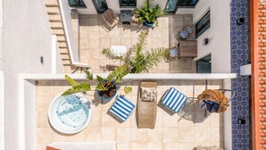 A rooftop terrace with a hot tub, lounge chairs, potted plants, and a pool table. - City-center townhouse with patio, Stylish 3 bedroom townhouse near Portimão promenade, 15 mins to Praia da Rocha. Private unit in historic building with shared patio, AC in all rooms, fast Wi-Fi, and modern comforts. (Portimao)