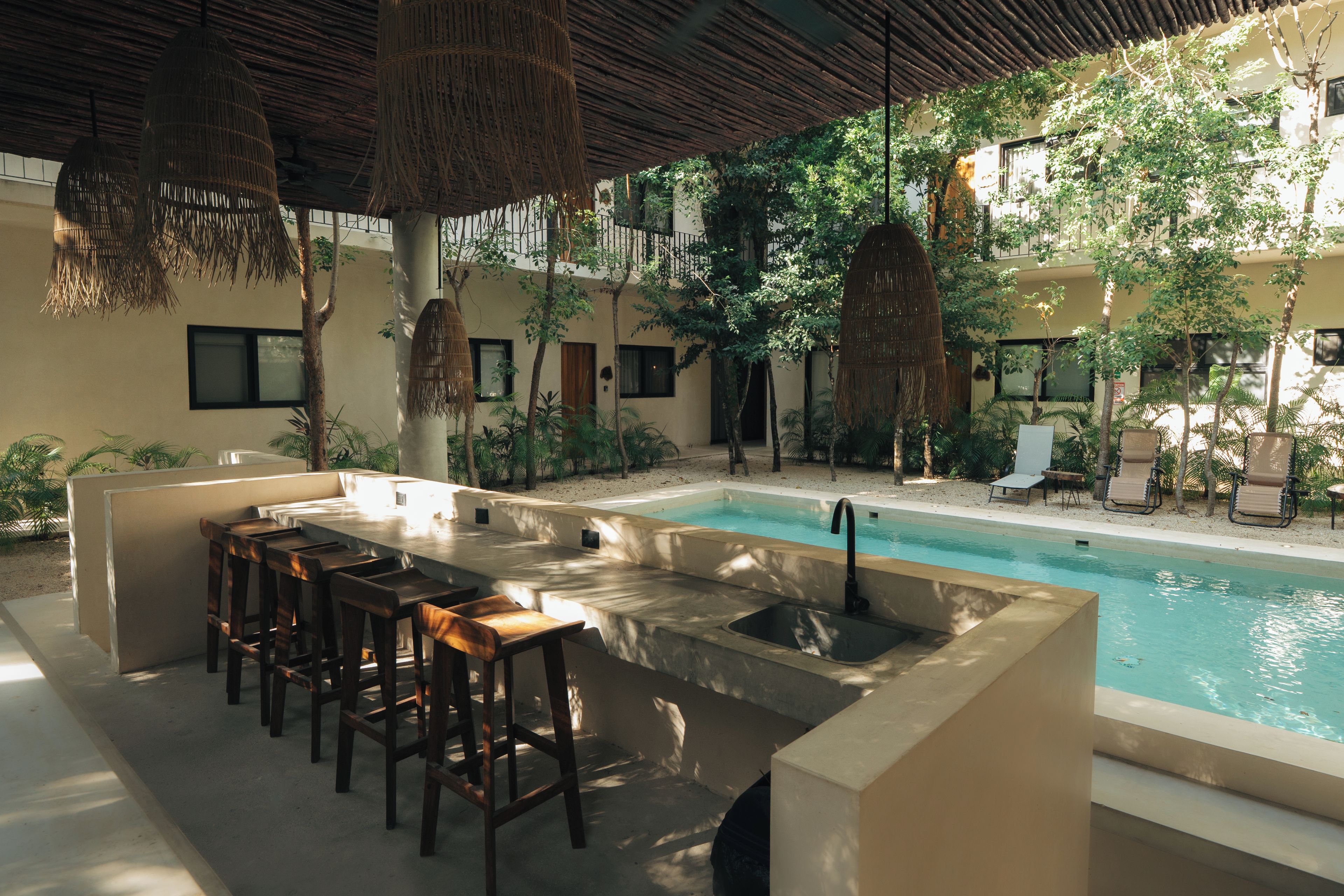 A poolside area with a bar and seating.