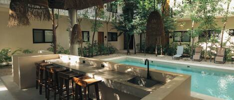 A poolside area with a bar and seating.