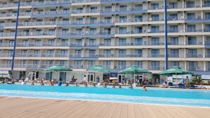 A hotel with multiple balconies, a swimming pool, and outdoor seating areas. - Stay at Black Sea, Olimp Romania (Olimp)