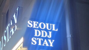 A sign for "SEOUL DDJ STAY" with a modern design and illuminated letters. - Seoul DDJ STAY (Seoul)