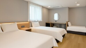 A hotel room with three beds, a desk, a mirror, and a window with sheer curtains. - Seoul DDJ STAY (Seoul)