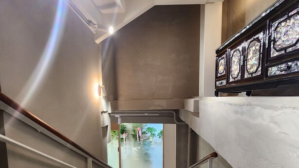 A modern interior with a staircase, glass walls, and a view of an outdoor area. - Seoul DDJ STAY (Seoul)