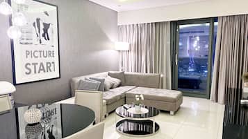 Deluxe Apartment, City View | Living area | 55-inch LED TV with satellite channels