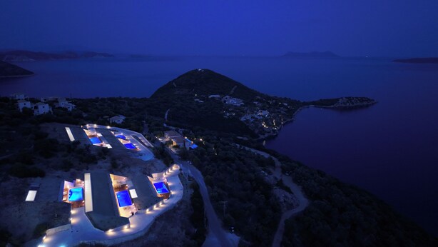 A coastal resort with multiple swimming pools, a winding road, and a view of the sea and distant mountains. - 2S Villas Resort - cave villas - Villa Epsilon E - Luxury Comfort Stay (Sivota)