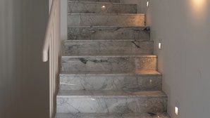 A staircase with marble steps and wall-mounted lighting. - Liberty Suites Spetses  (Spetses)