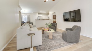 A living room with a sofa, armchair, coffee table, and a ceiling fan. - 6 Mi to State Farm Stadium: Avondale Family Home! (Avondale)