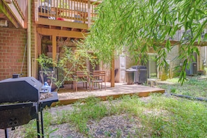 A backyard with a barbecue grill, wooden deck, and outdoor seating area. - < 25 Mi to Downtown Baltimore & DC: Apt w/ Deck (Columbia)