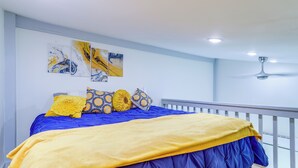 A bedroom with a bed, a ceiling fan, and artwork on the wall. - River Access & Private Deck: Mountain View Retreat (Mountain View)