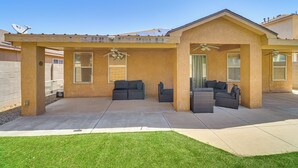 A covered patio area with two sofas and a dining table, a ceiling fan, and a view of the backyard. - 4 Mi to Old Town: Pet-friendly Home w/ Fenced Yard (Albuquerque)