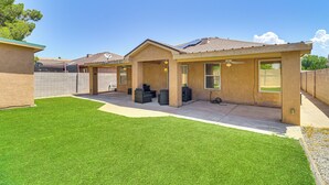 A residential house with a covered patio, a lawn, and a garage. - 4 Mi to Old Town: Pet-friendly Home w/ Fenced Yard (Albuquerque)